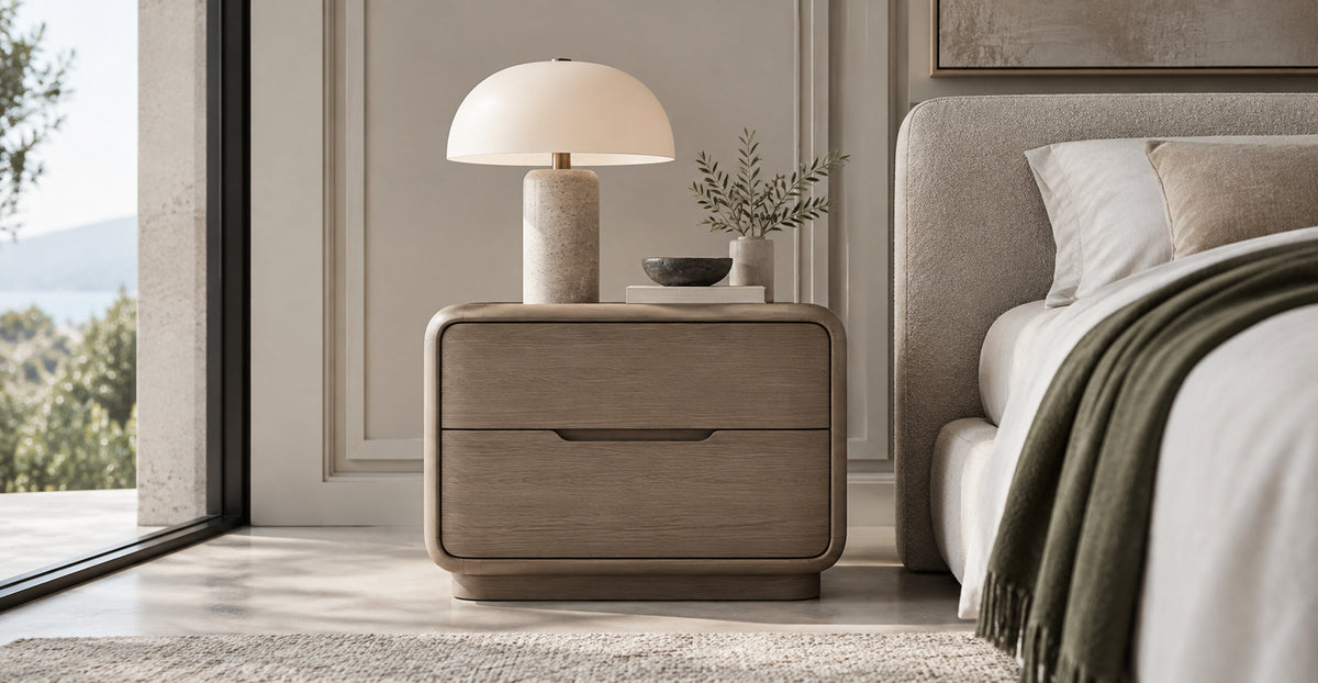 Modern rounded wood two-drawer nightstand beside a bed — Ivaaj
