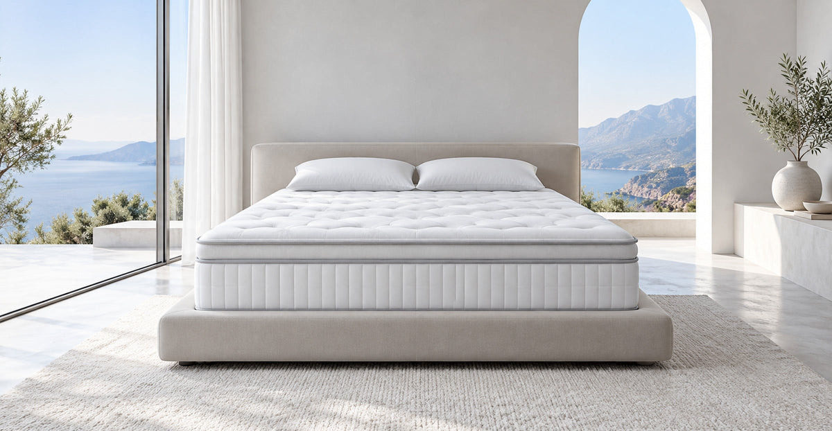 Quilted hybrid memory foam mattress displayed uncovered in a bright bedroom — Ivaaj
