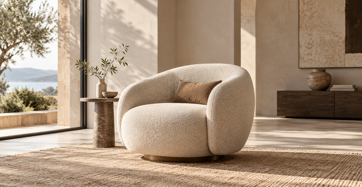 Sculptural cream boucle armchair in a sunlit minimalist living space