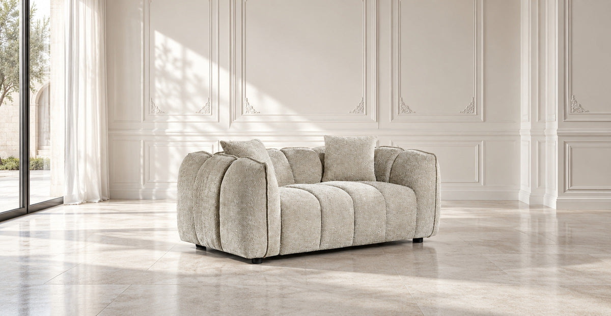 Beige two-seater sofa in an elegant light European living room