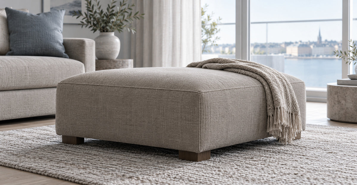 Upholstered rectangular footstool in a cool Scandinavian living room — Ivaaj