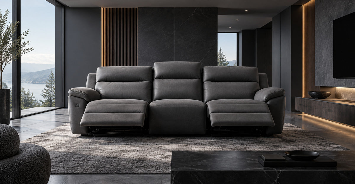 Leon dark grey electric reclining three-seater sofa with raised footrests in a contemporary lounge — Ivaaj